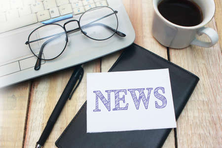 News words letter written on piece of paper memo work desk top view business typography concept