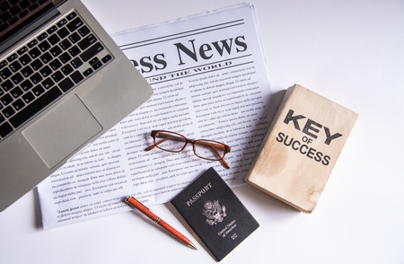 Black coffee and dollar is placed on a desk with office equipment and placed