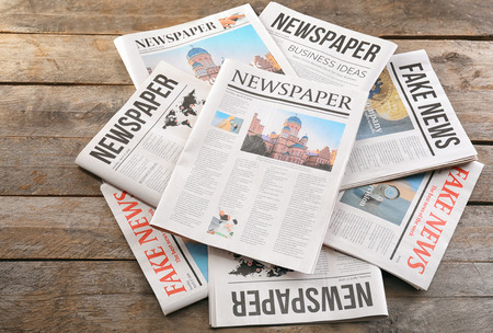 Newspapers on wooden background