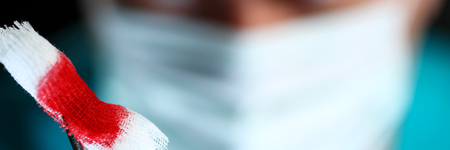 Surgeon in sterile uniform arms holding tools with bio material Stock Photo