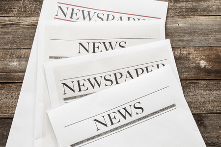 Newspaper on wooden background Stock Photo