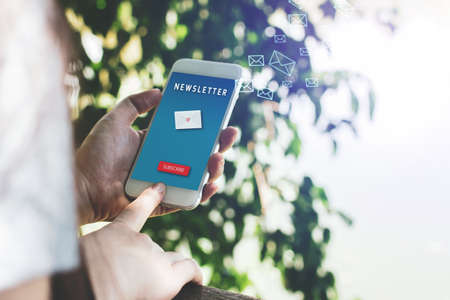 Newsletter concept hand of asian woman checking message box on digital mobile phone outdoor