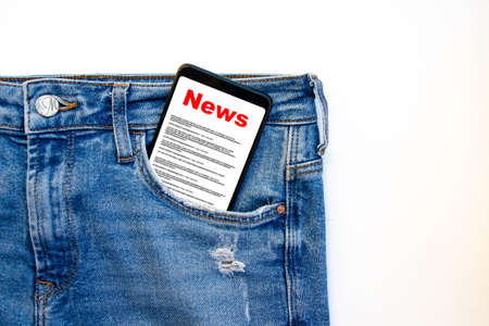 News reading the news the inscription red news on the smartphone screen lies in a jeans pocket a smartphone with a red inscription news sticks out of a jeans pocket on a white background
