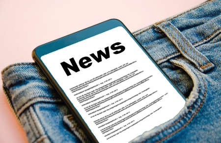 News reading the news the inscription black news on the screen of a smartphone that lies in a jeans pocket a smartphone with a black inscription news sticks out of a jeans pocket on a pink background Stock Photo