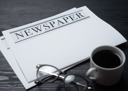 Blank business newspaper and coffee with with glasses on table daily newspaper mock up concept