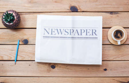 Newspaper with coffee on the table