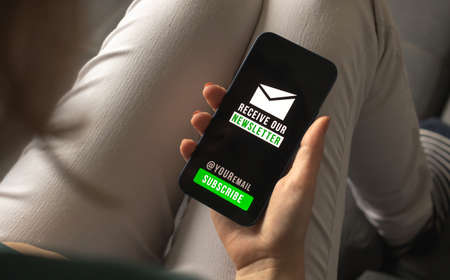 Woman join the newsletter web technology and email marketing concept background mobile phone with newsletter signup page closeup photo