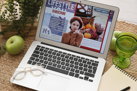 Laptop with eyeglasses notebook and accessories of blogger on carpet