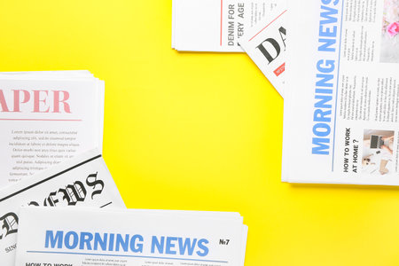 Frame made of newspapers on color background