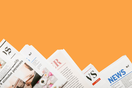 Different newspapers on color background Stock Photo