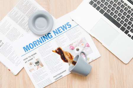 Cup and spilled coffee on wooden table