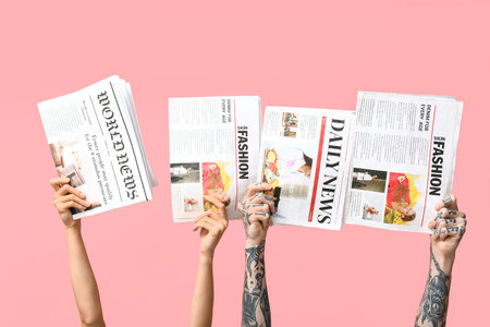 Female and male hands with newspapers on pink background Stock Photo