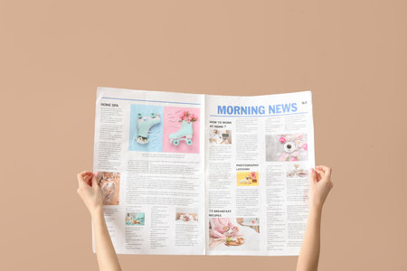 Woman with newspaper on beige background