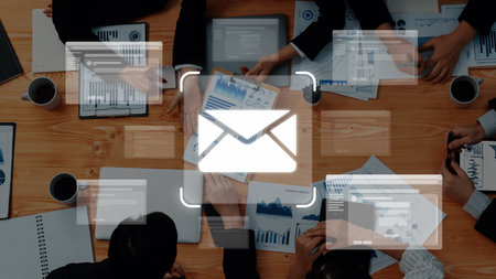 Engaging teamwork around a desk filled with business reports and digital devices emphasizing collaboration and effective communication in modern workplace settings raster Stock Photo