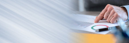 Businessman analyzing marketing charts at office closeup panoramic banner