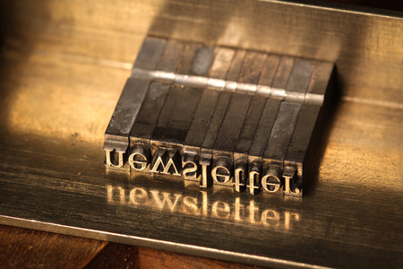 Composing stick with the letters