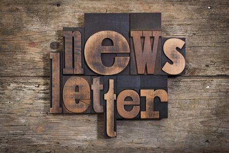 Newsletter word set in two lines with vintage letterpress printing blocks on rustic wooden background Stock Photo