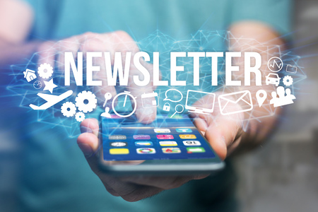 Concept view of man holding futuristic interface with newsletter title and multimedia icons flying all around internet concept