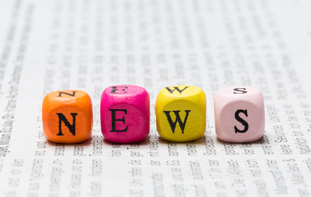 News letter cubes on newspaper macro Stock Photo