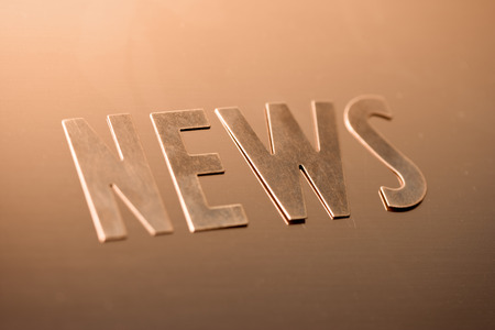 The word news on a copper background Stock Photo
