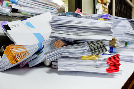 Busy messy and cluttered workplace full of documents