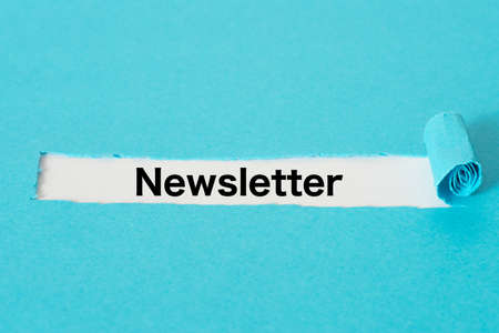Piece of blue paper and the word newsletter